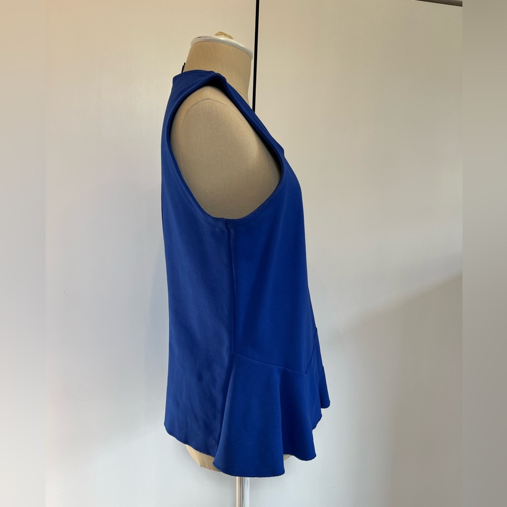 J Crew top with slight peplum detail. Size L.